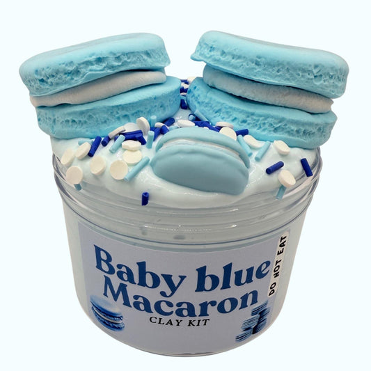 Baby blue macaron clay kit with white frosting and sprinkles in a clear container on a white background.